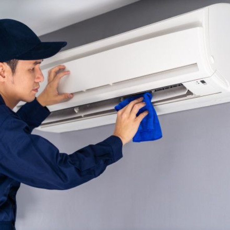 Technician performing AC maintenance in Dubai