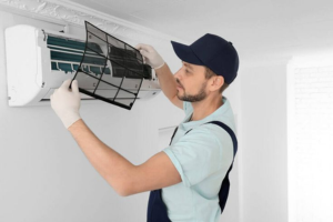 Technician installing split AC system in Dubai