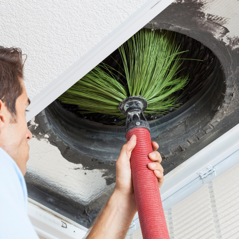 Technician performing AC duct cleaning Dubai