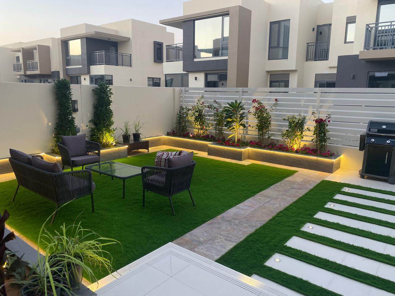 Modern villa landscaping in Dubai with pergola, lighting and lush planting